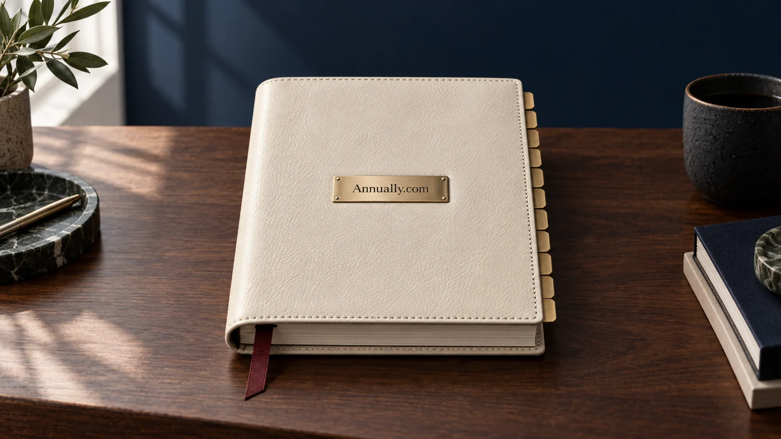 An ivory yearly planner with an Annually.com brass plaque